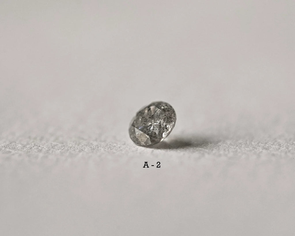 Raw diamond on a light gray background