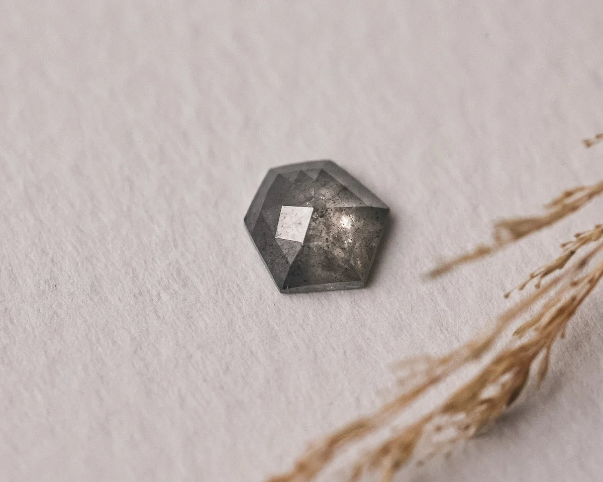Close-up of loose grey hexagonal rose-cut diamond with natural texture