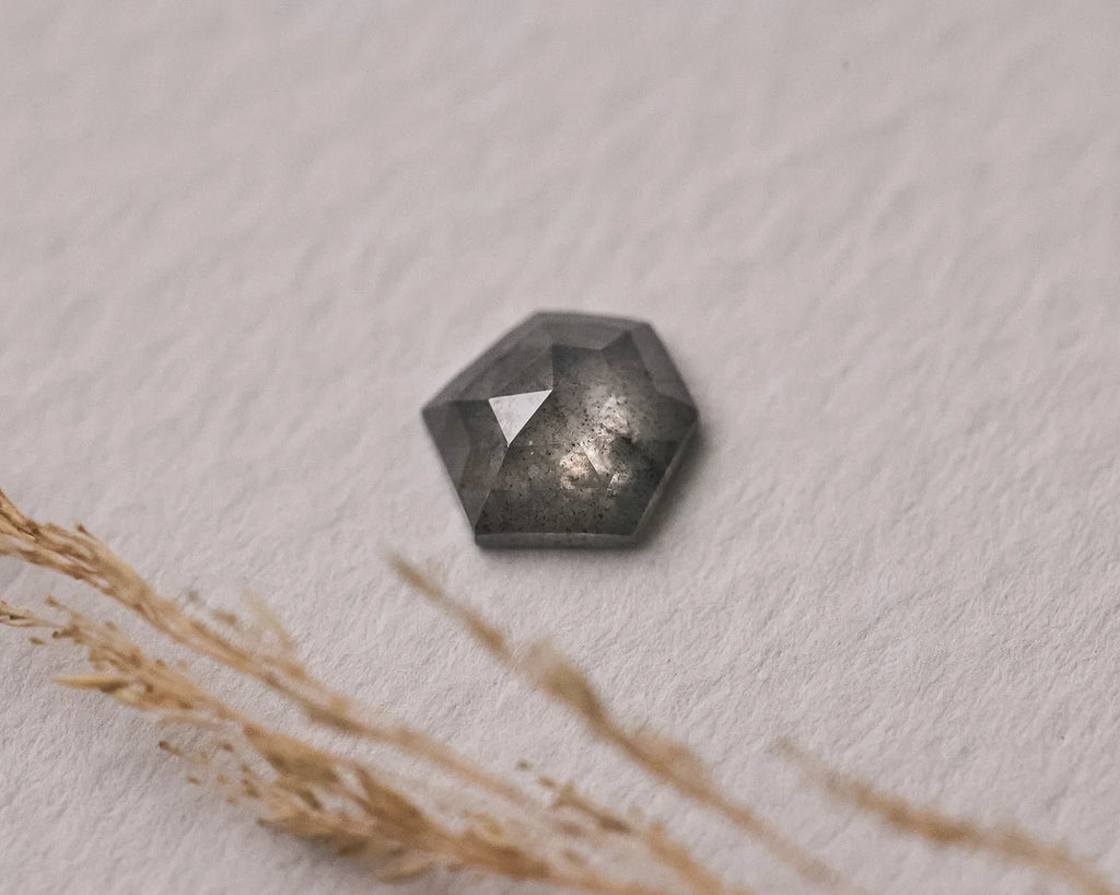  Loose salt and pepper rose-cut hexagonal diamond on textured background