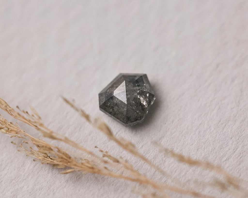 Close-up of hexagonal grey rose-cut diamond for custom trilogy ring