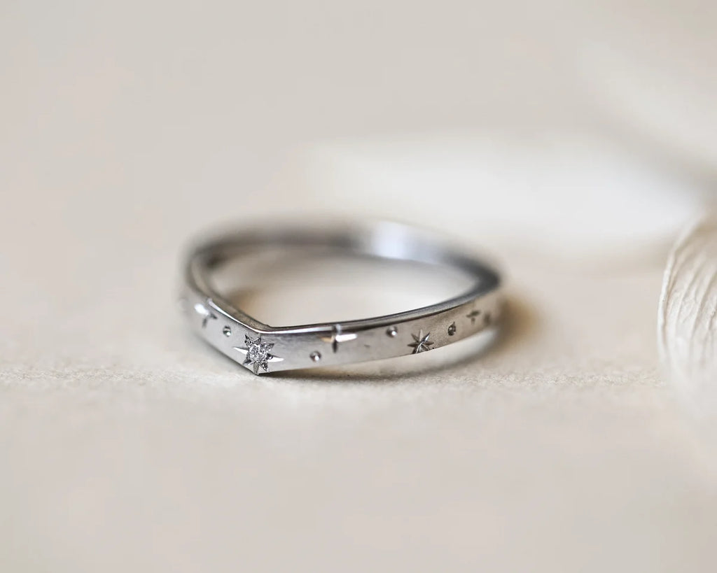 minimal platinum band star set stone texture detail
