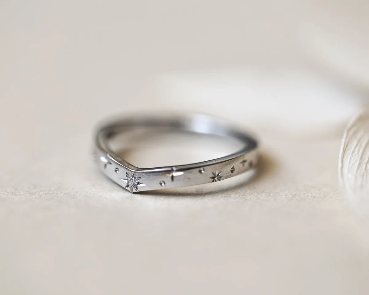minimal platinum band star set stone texture detail