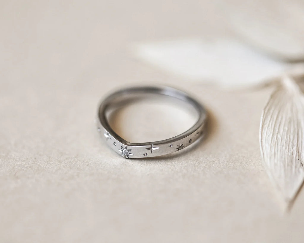 Minimal platinum star set diamond wishbone ring with pale leaf styling