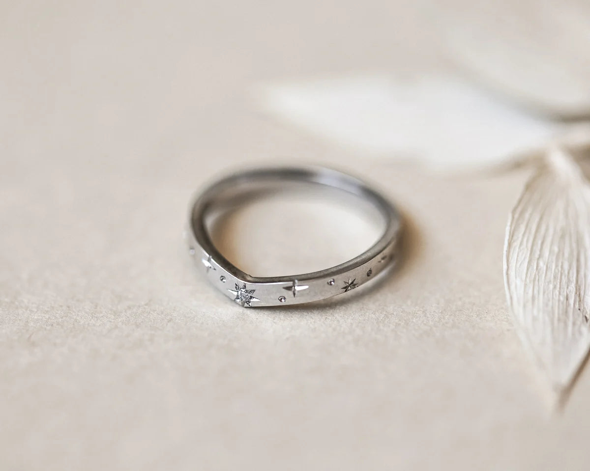 Minimal platinum star set diamond wishbone ring with pale leaf styling
