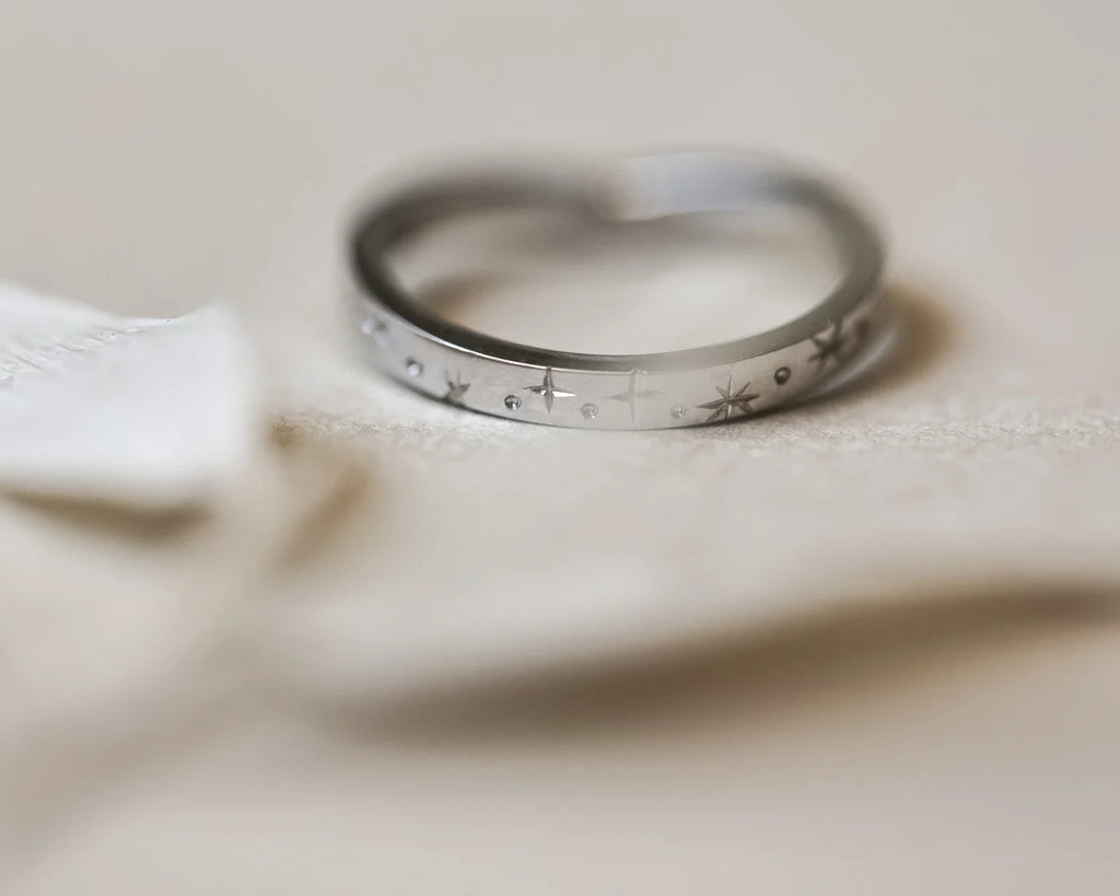 Front view of platinum star set diamond wishbone eternity ring