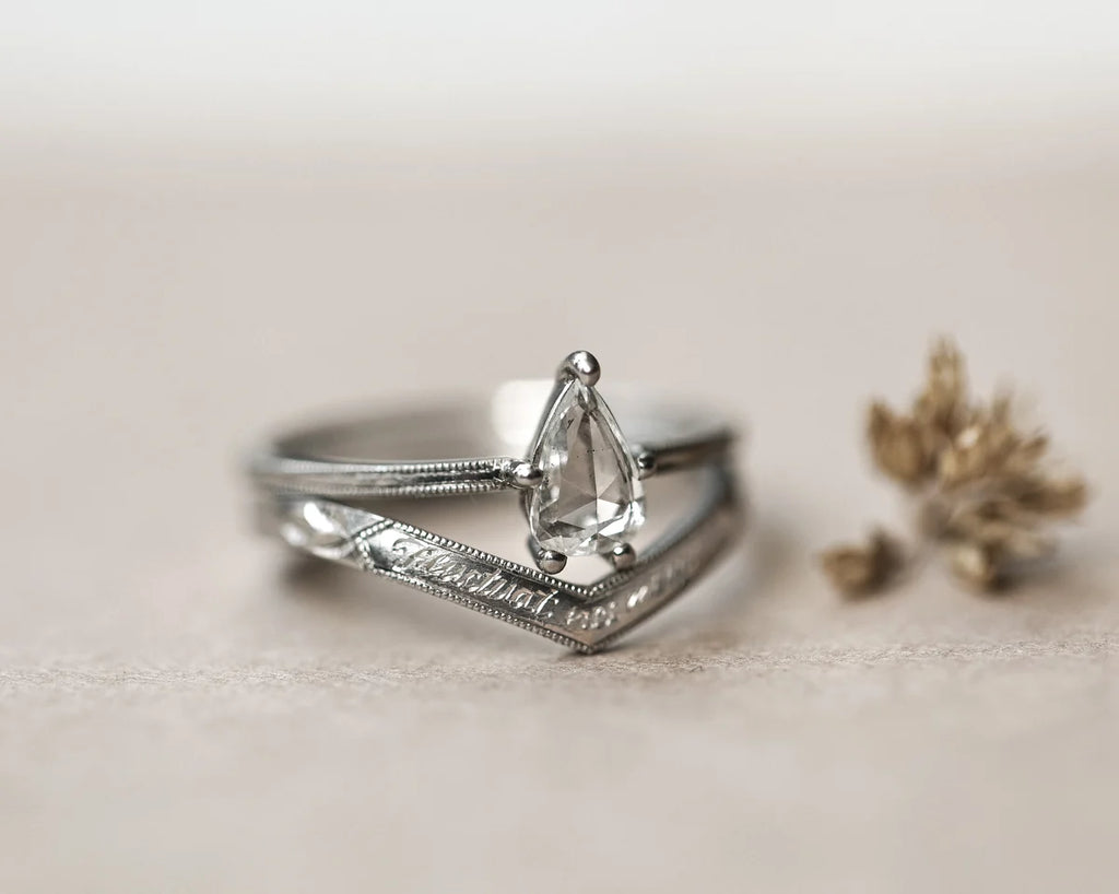 Silver ring with a diamond on a light background