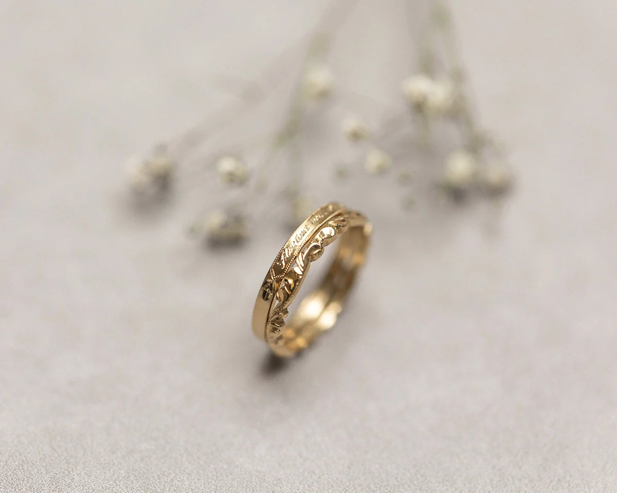 two gold engraved and carved wedding rings