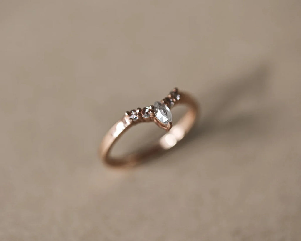 Soft focus view of milky grey marquise diamond ring in rose gold