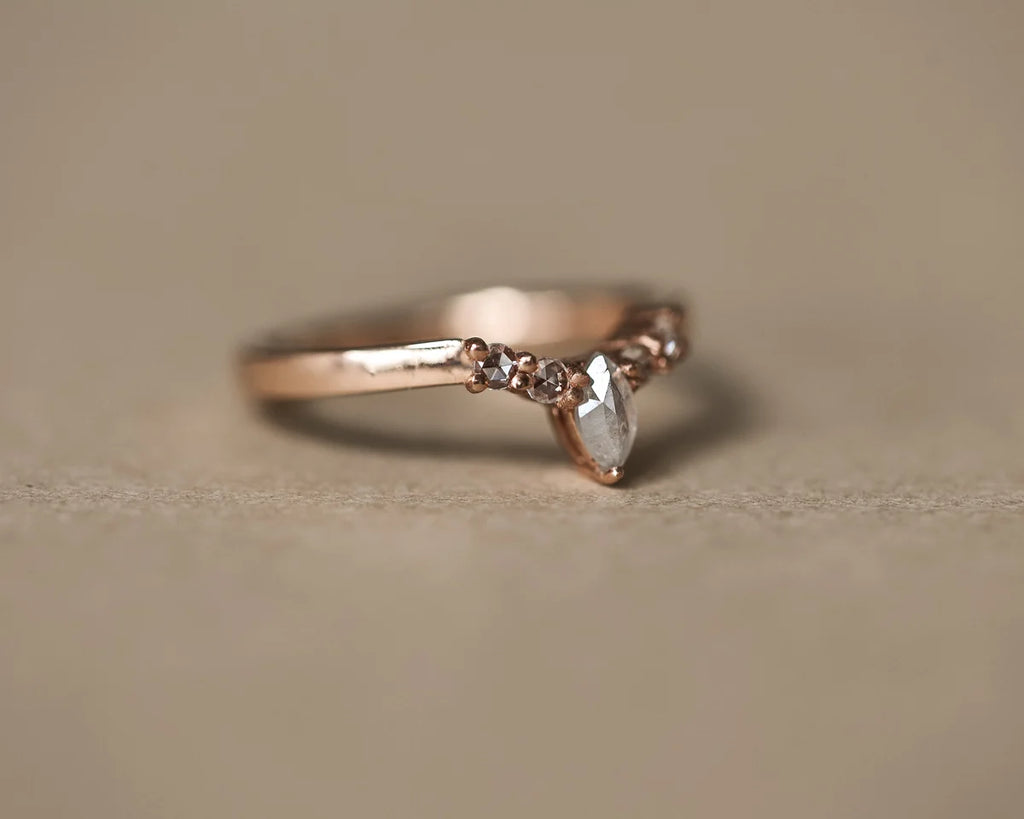 Low side view of marquise diamond wishbone ring in rose gold