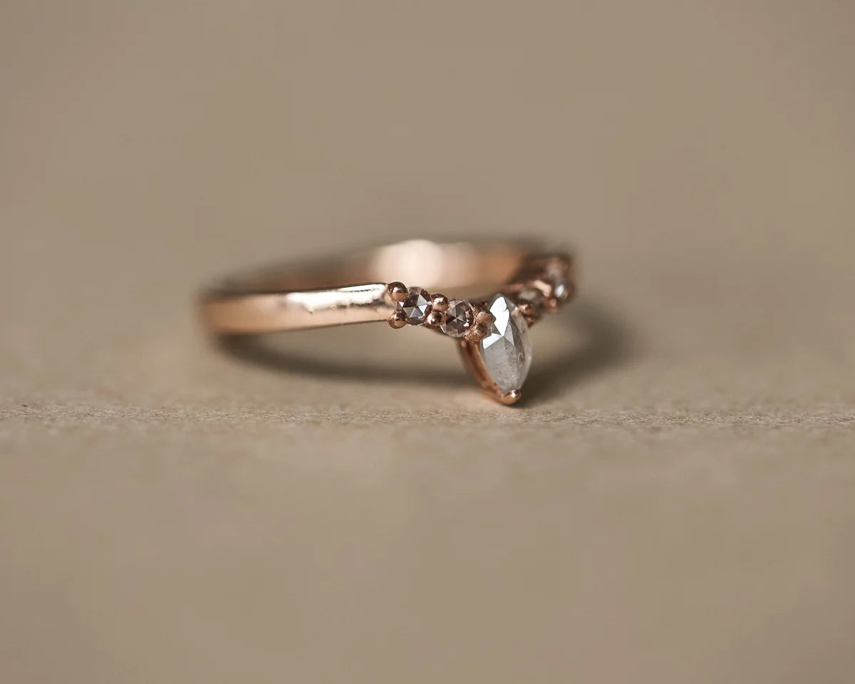 Low side view of marquise diamond wishbone ring in rose gold