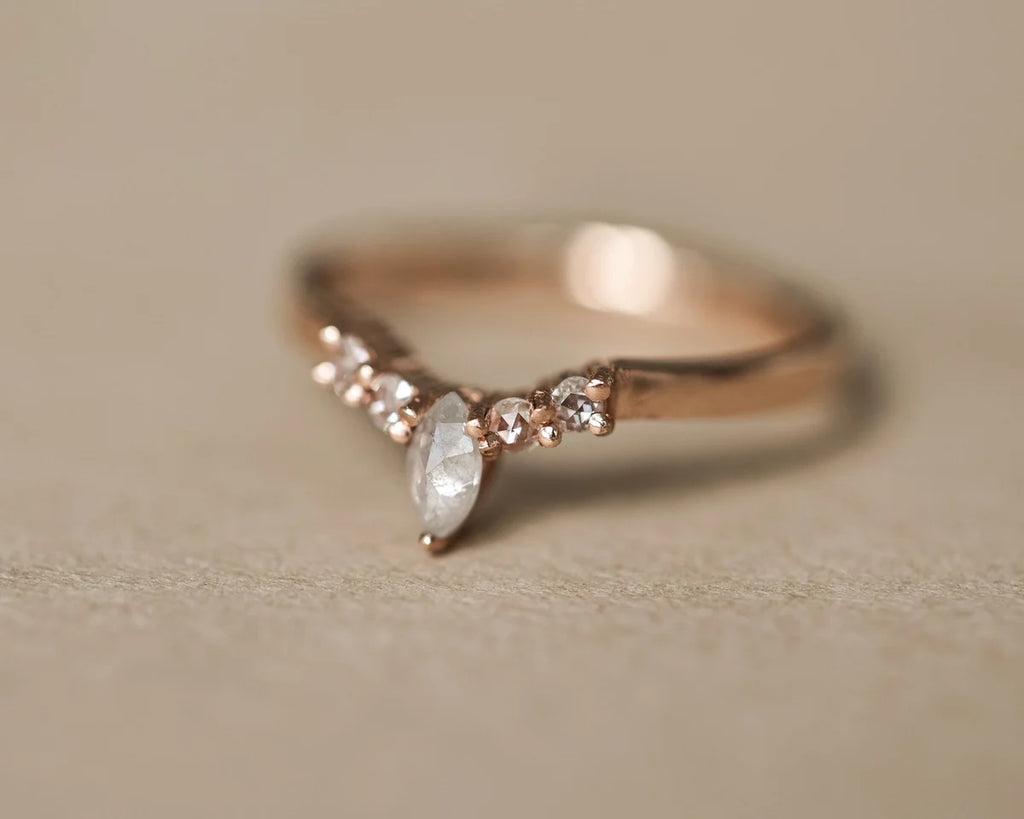 Angled view of rose gold wishbone ring with milky grey marquise diamond