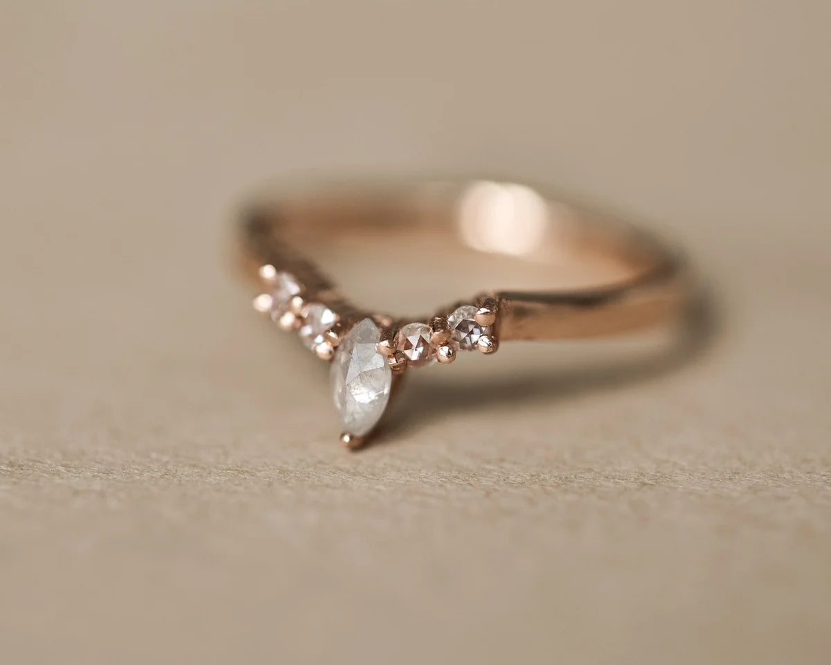 Angled view of rose gold wishbone ring with milky grey marquise diamond