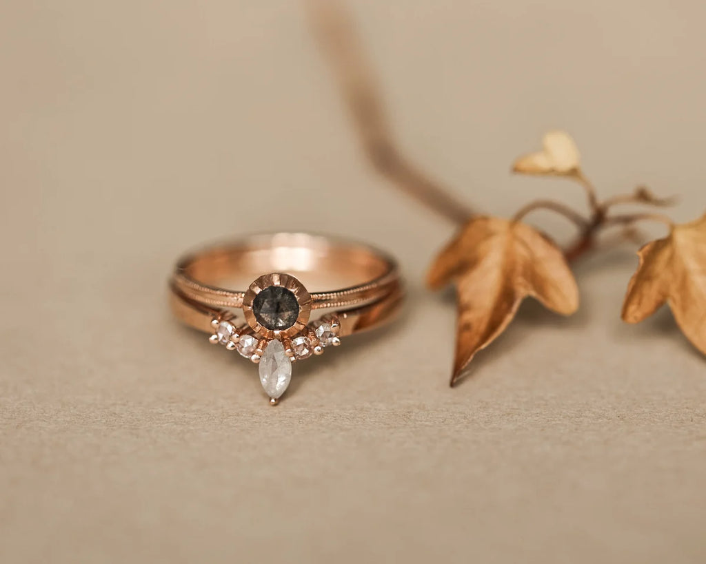 Rose gold diamond wishbone ring styled with autumn leaves