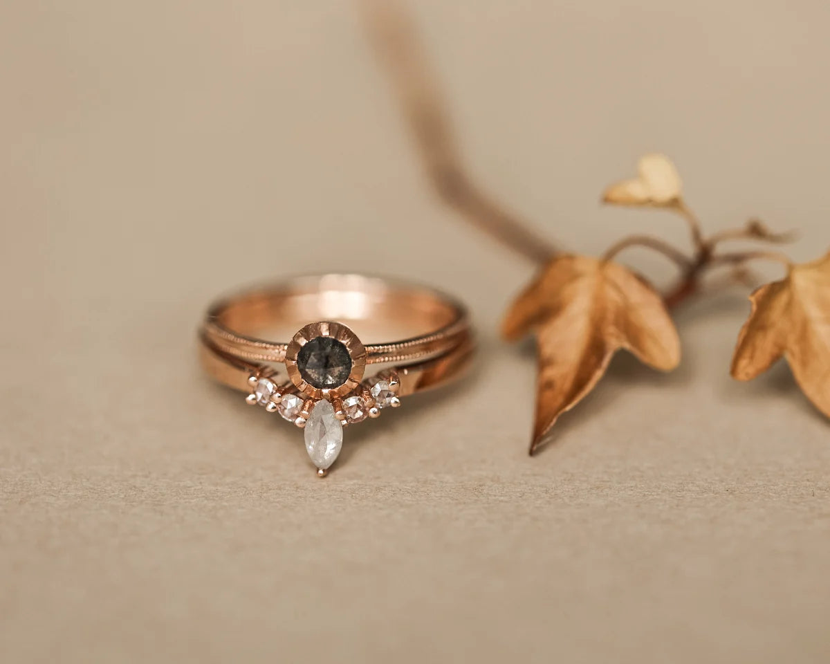Rose gold diamond wishbone ring styled with autumn leaves