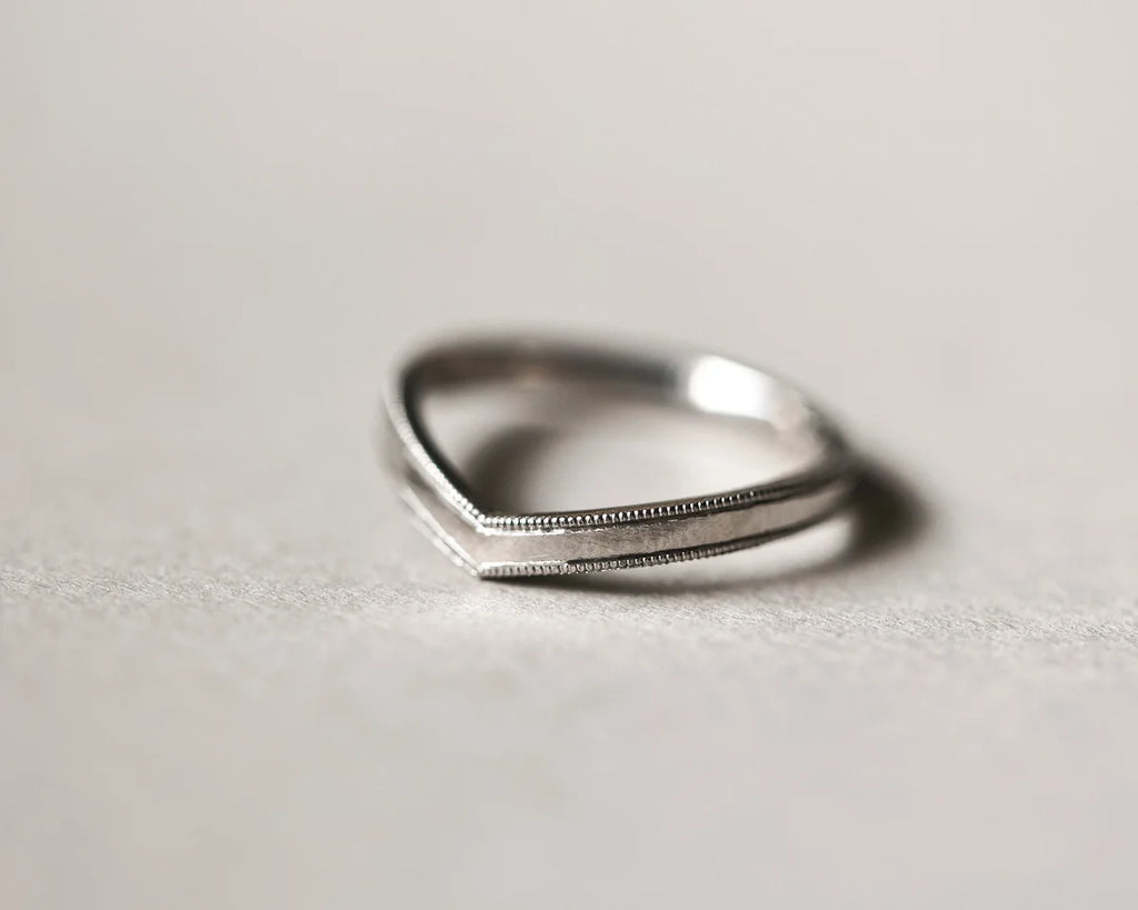 Front view of platinum milled edge wishbone ring