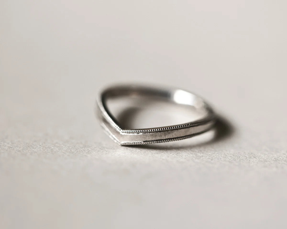 Front view of platinum milled edge wishbone ring