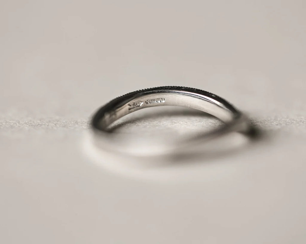 Side profile of handmade milled edge wishbone ring in platinum