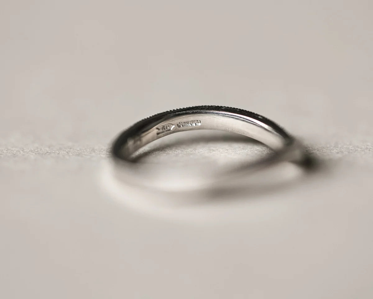Side profile of handmade milled edge wishbone ring in platinum