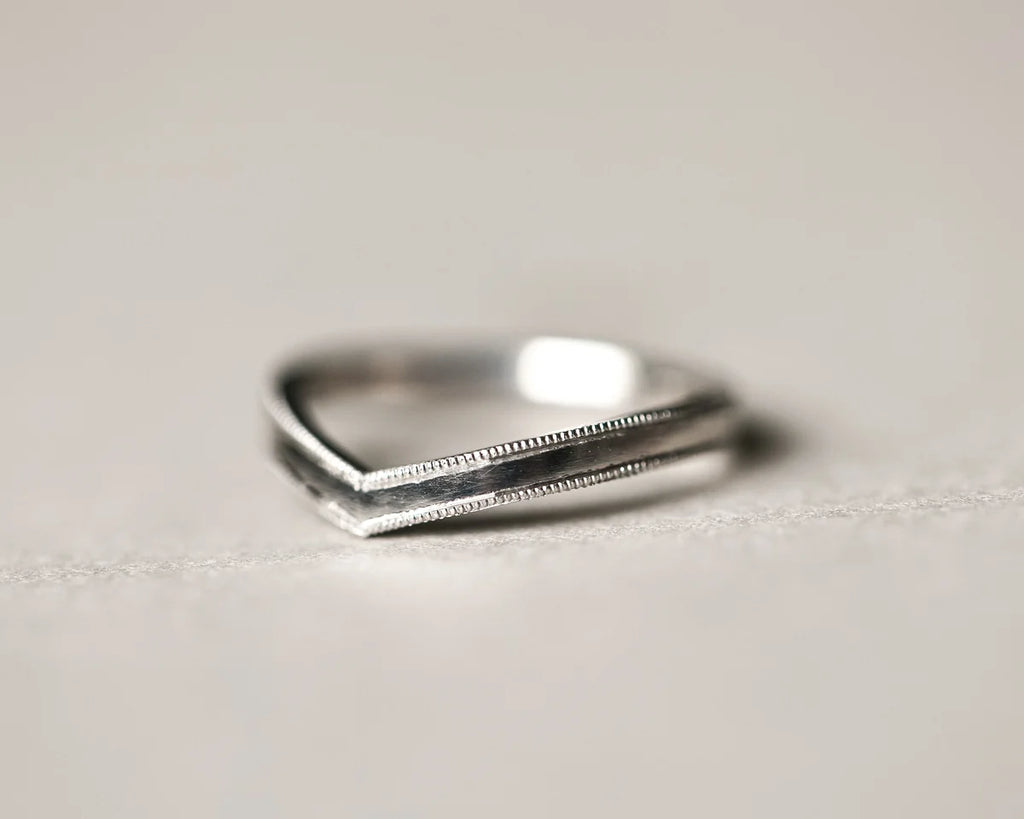 Low front view of 2mm platinum milled edge wishbone ring