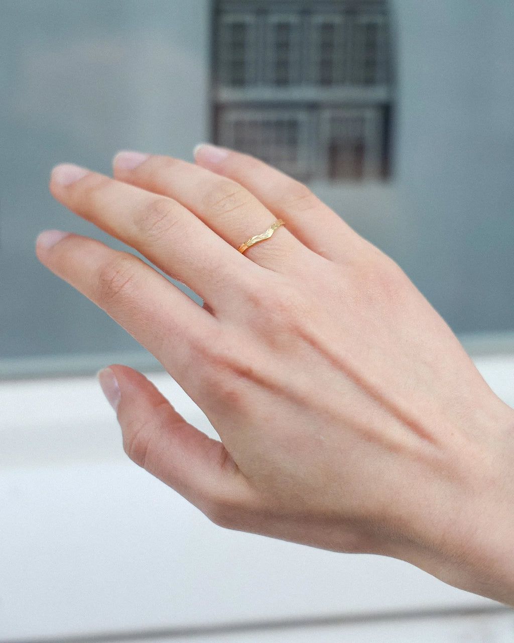     18ct yellow gold olive leaf wishbone ring worn on hand