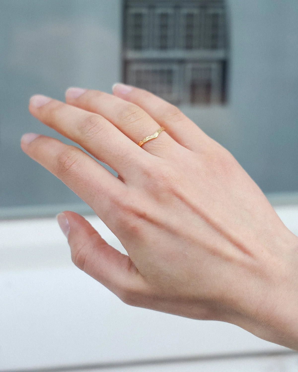     18ct yellow gold olive leaf wishbone ring worn on hand