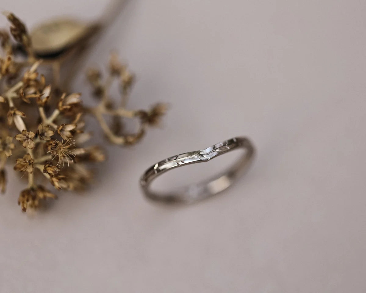 Angled view of handmade willow leaf wishbone ring in white gold