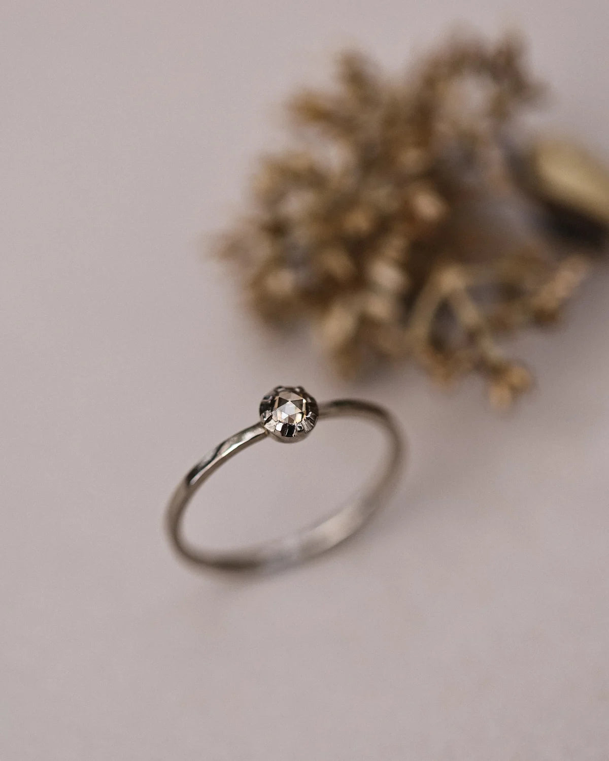Angled view of handmade champagne diamond ring in white gold