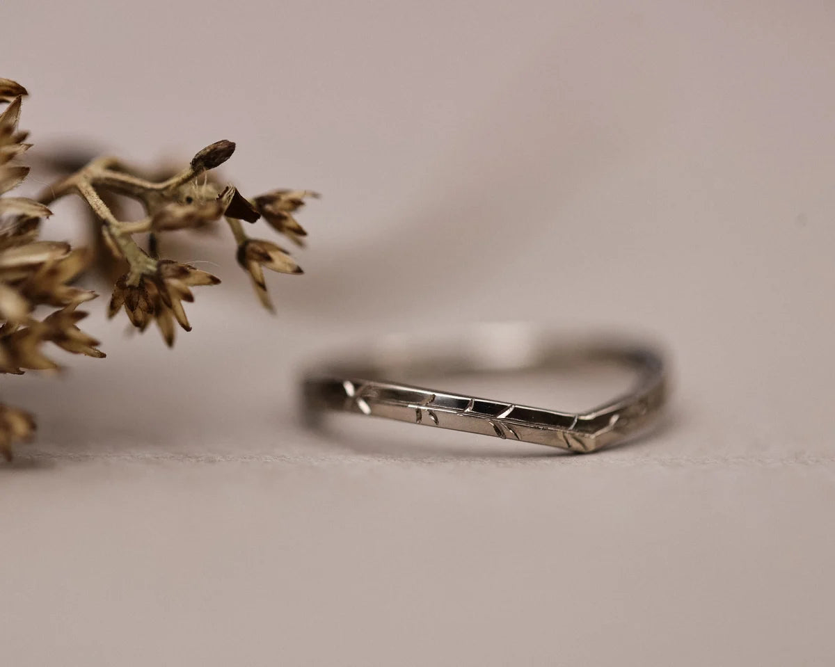 Close-up of 18ct white gold willow leaf engraved wishbone ring