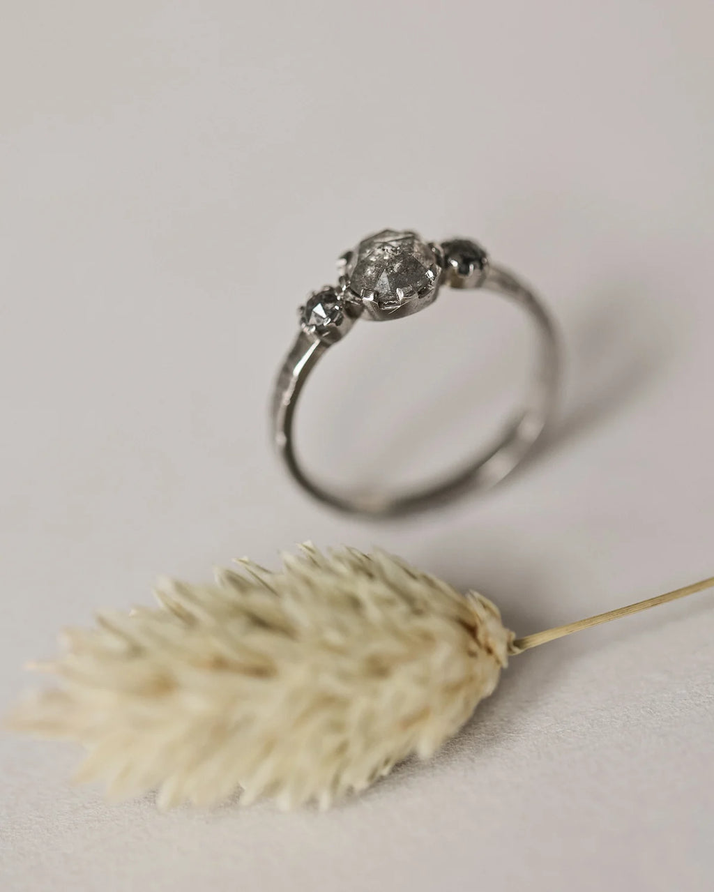 Side profile of platinum horn texture trilogy ring