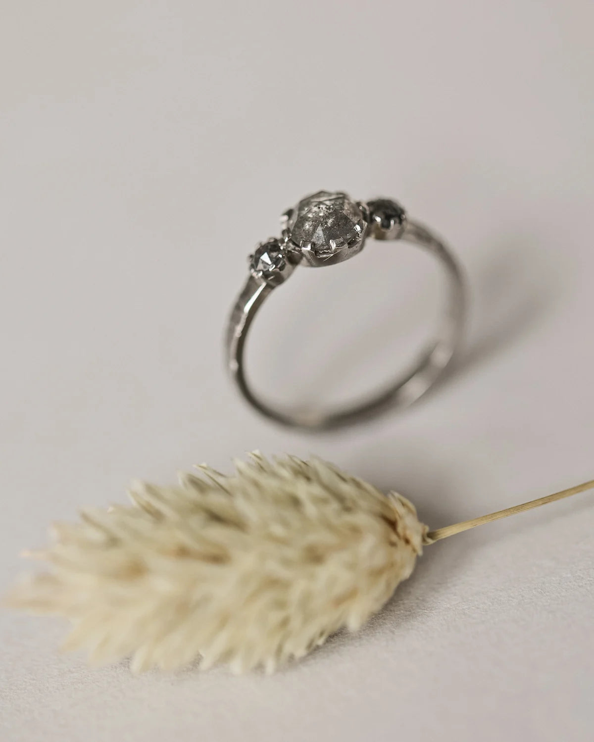 Side profile of platinum horn texture trilogy ring
