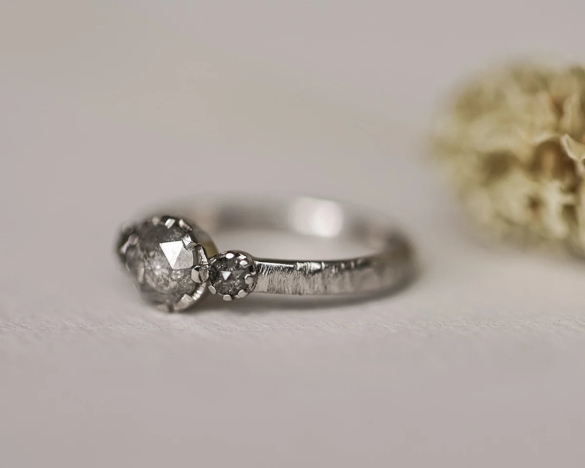 Front view of platinum pale grey diamond trilogy ring