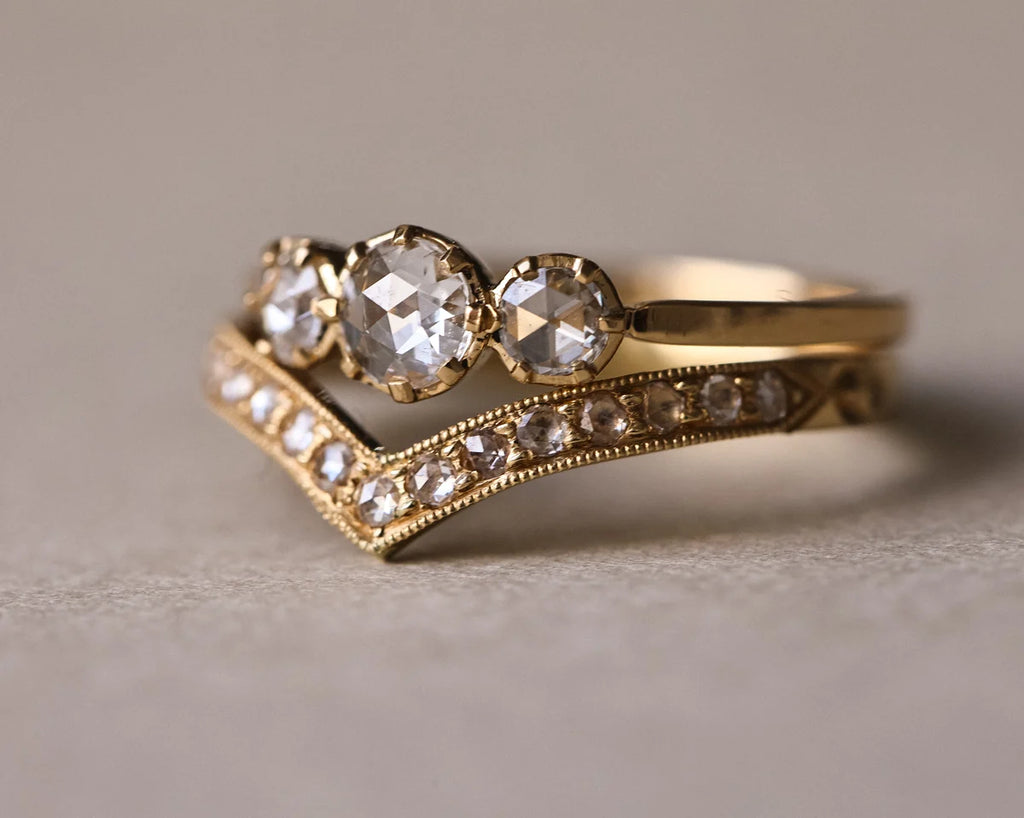 Rose-cut diamond trilogy ring paired with pavé wishbone wedding band