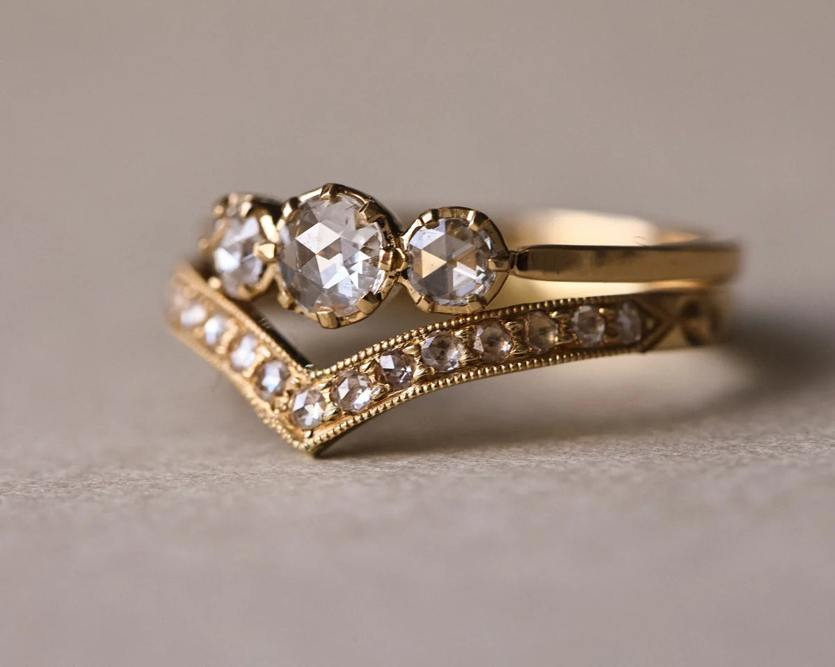 Rose-cut diamond trilogy ring paired with pavé wishbone wedding band