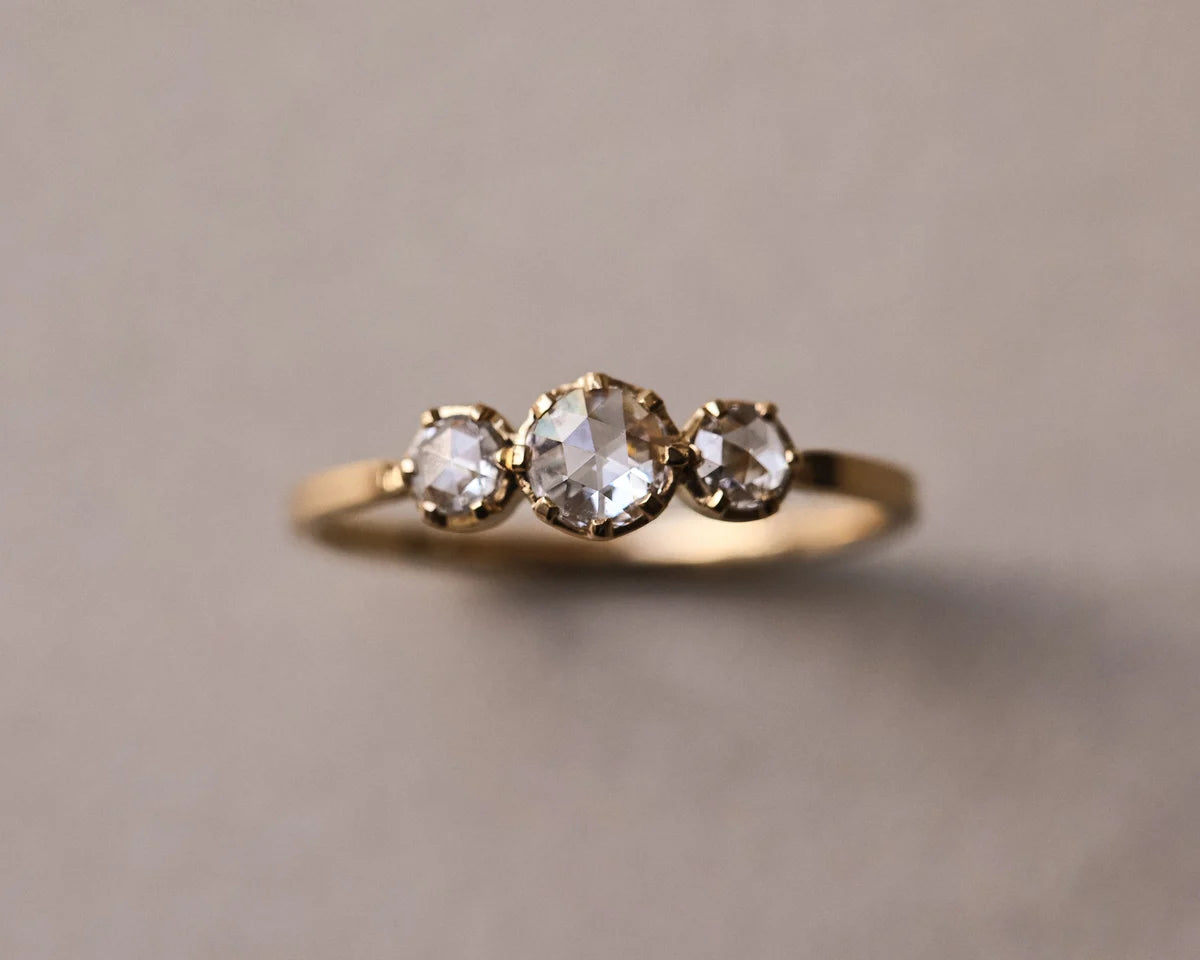 Front view of 18ct yellow gold trilogy ring with rose-cut diamonds