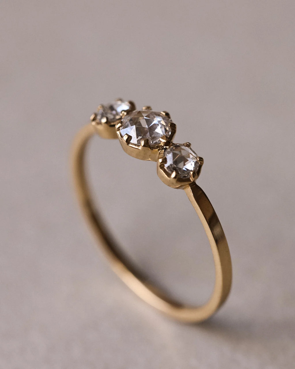 Portrait view of handmade 18ct yellow gold trilogy diamond ring