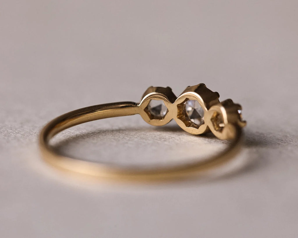 Back view of handmade trilogy ring showing three rose-cut diamond settings