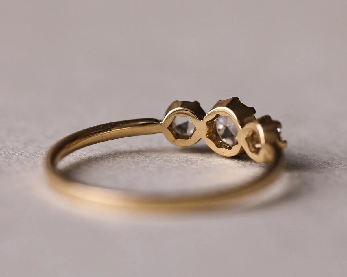 Back view of handmade trilogy ring showing three rose-cut diamond settings