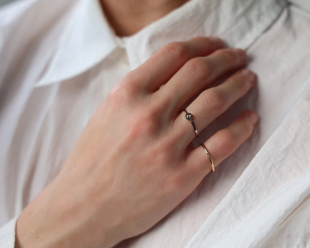 Champagne rose-cut diamond ring worn on hand with white shirt