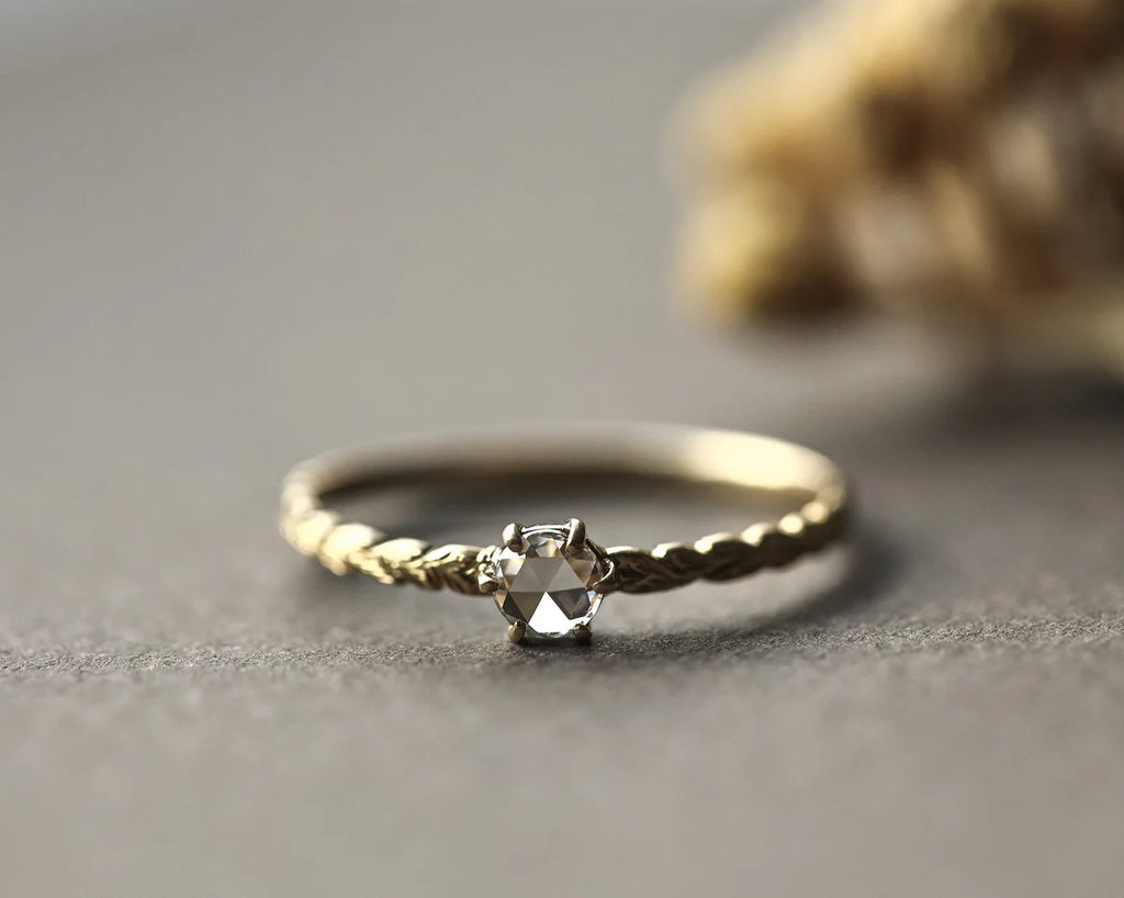 Front view of rose-cut diamond ring with carved laurel leaf band