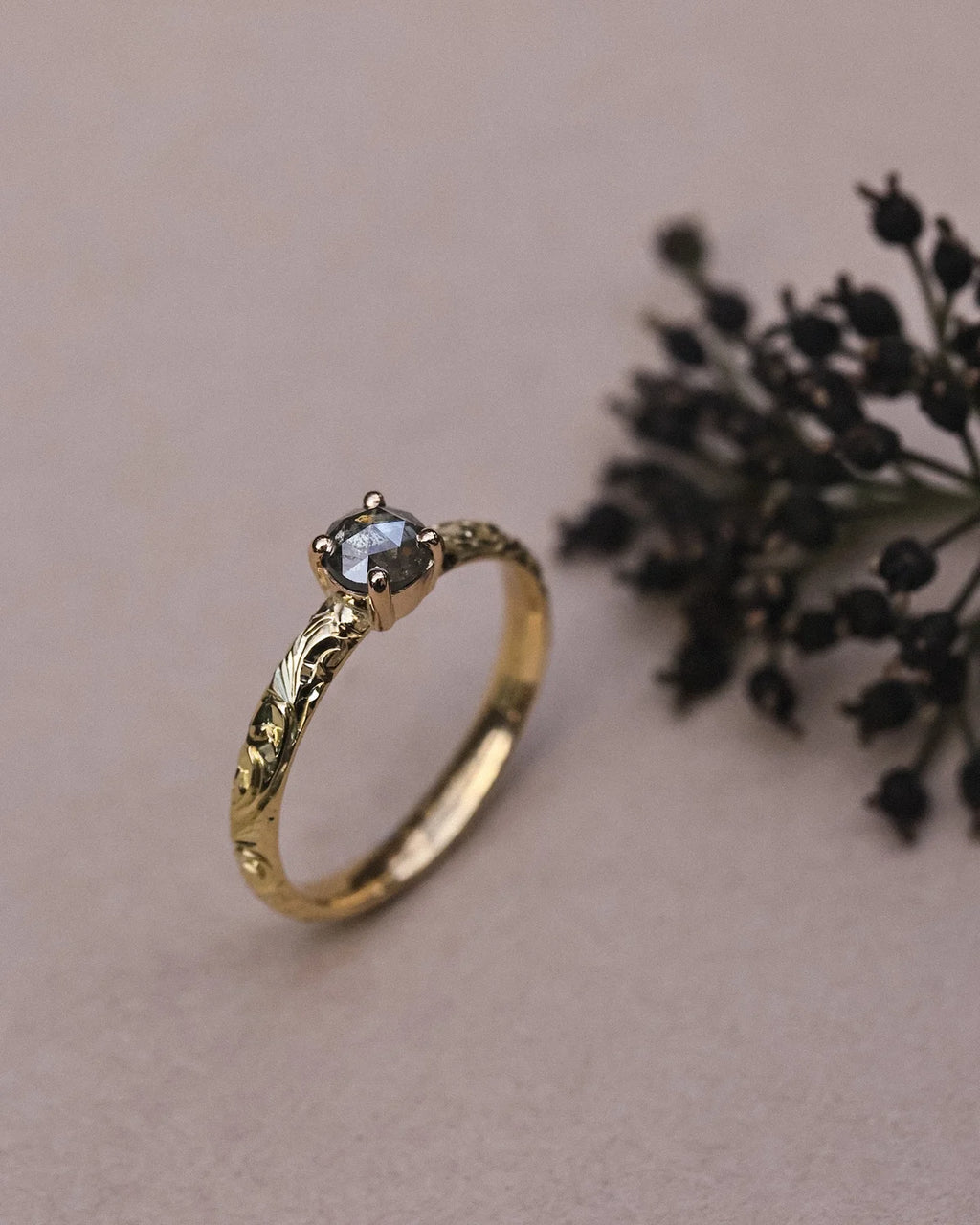 Side profile of handmade floral ring with rose-cut grey diamond
