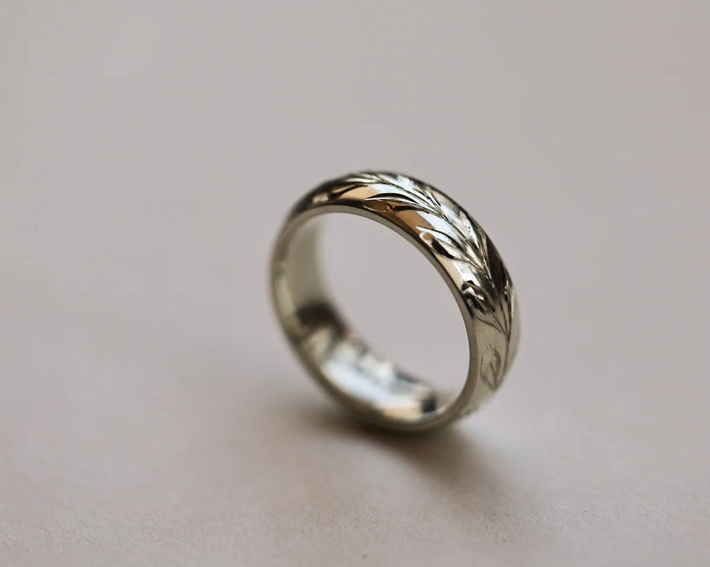 18ct white gold court wedding ring with hand engraved olive leaf motif