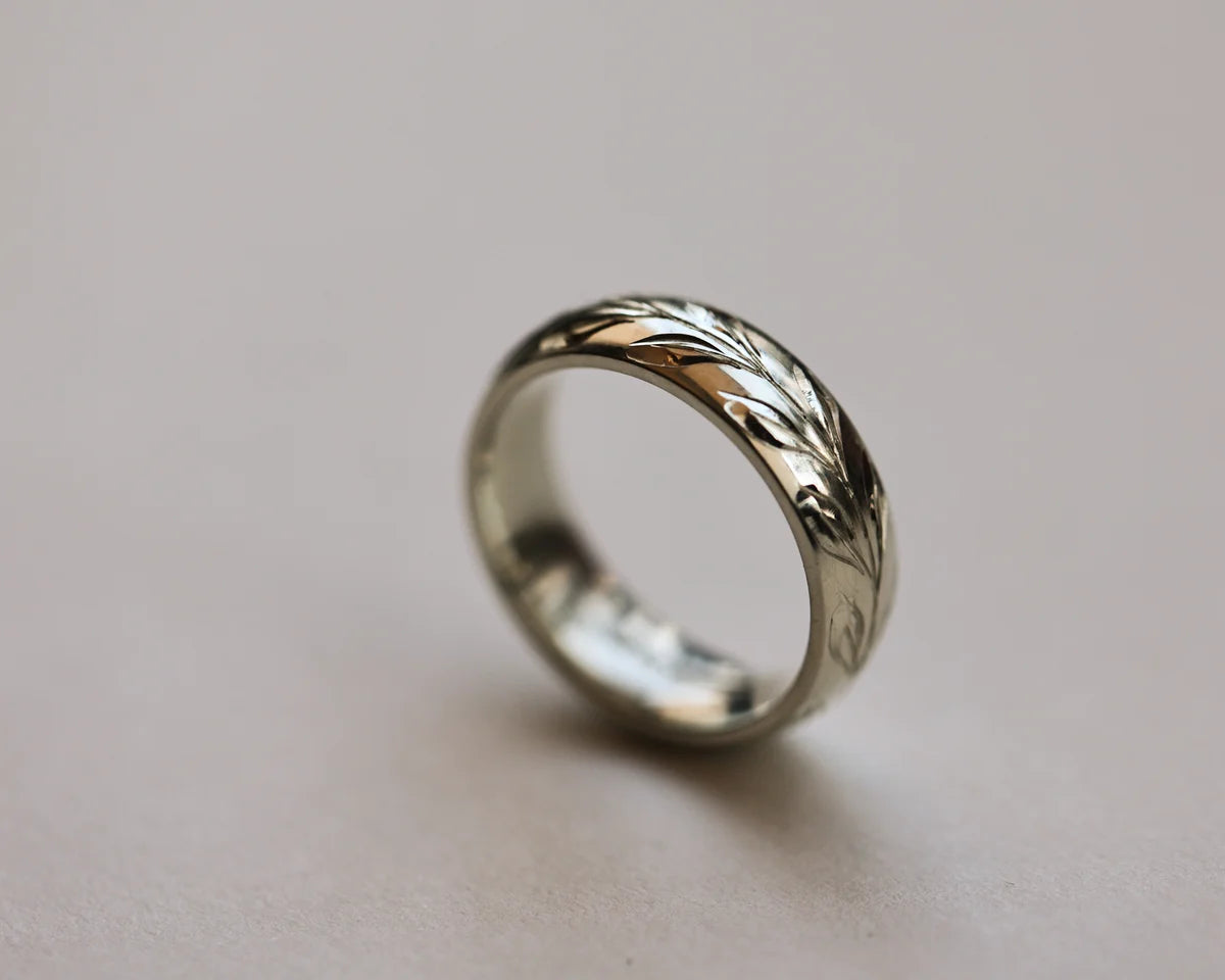 18ct white gold court wedding ring with hand engraved olive leaf motif