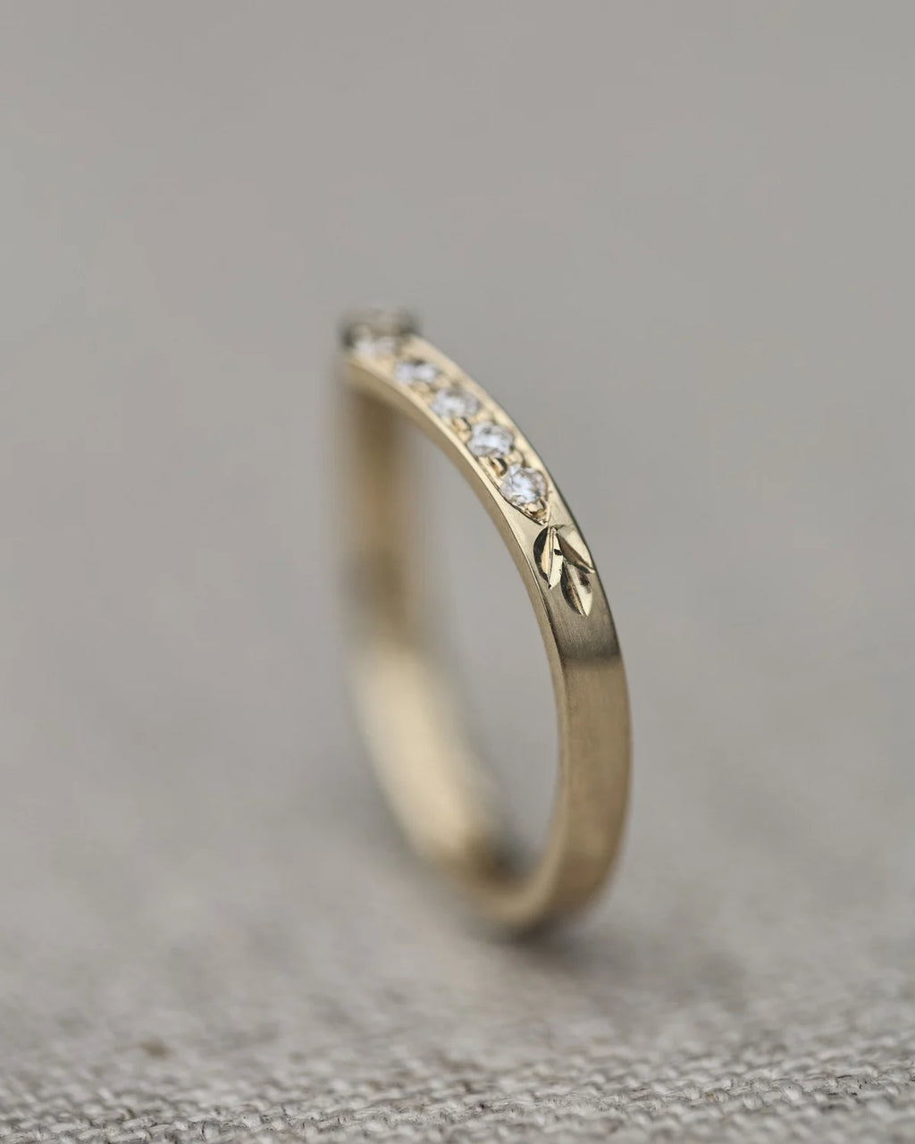 Side profile of yellow gold wishbone semi-eternity ring