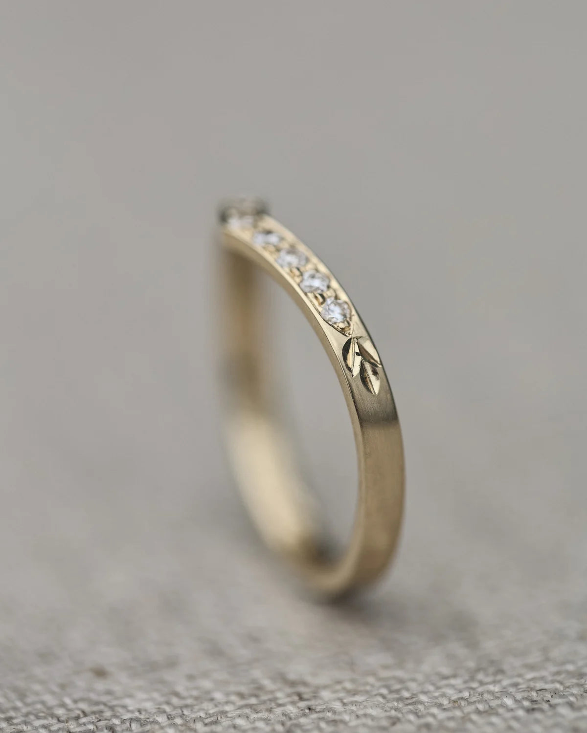 Side profile of yellow gold wishbone semi-eternity ring