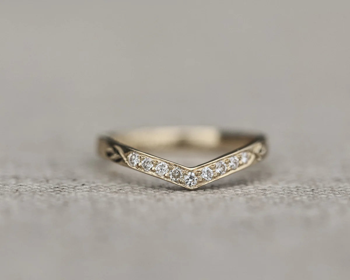 Front view of white gold diamond wishbone ring with pavé setting