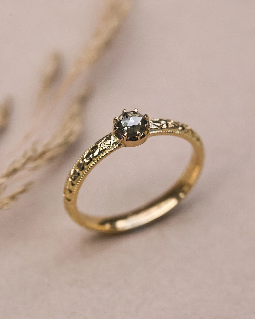 Angled close-up of grey rose-cut diamond orange blossom ring