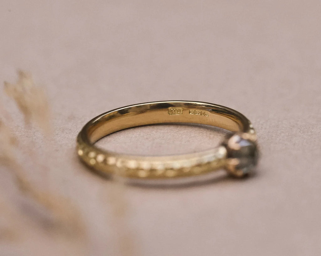 Side profile of 18ct yellow gold ring with grey rose-cut diamond