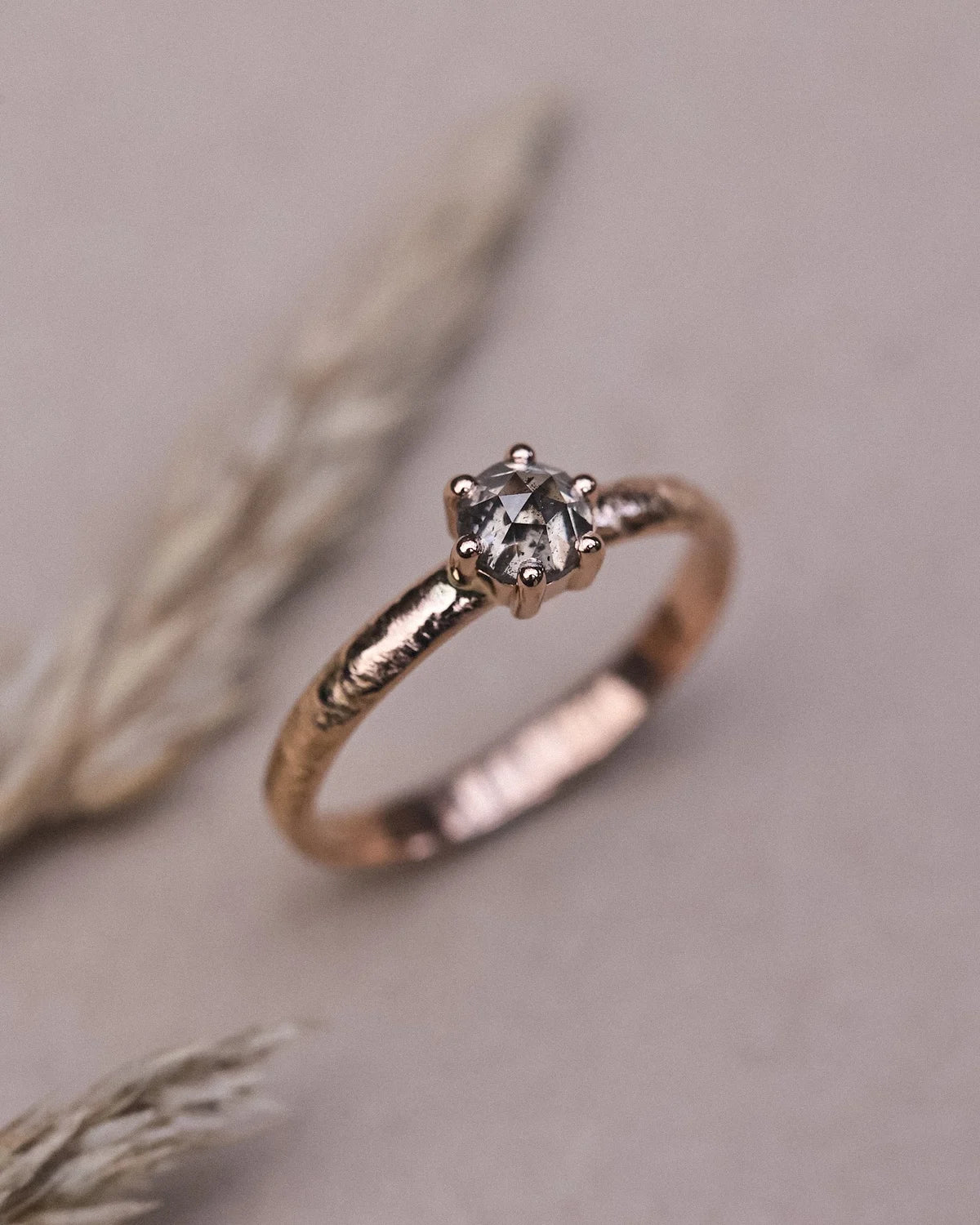 Grey rose-cut diamond ring in rose gold styled with dried botanical detail