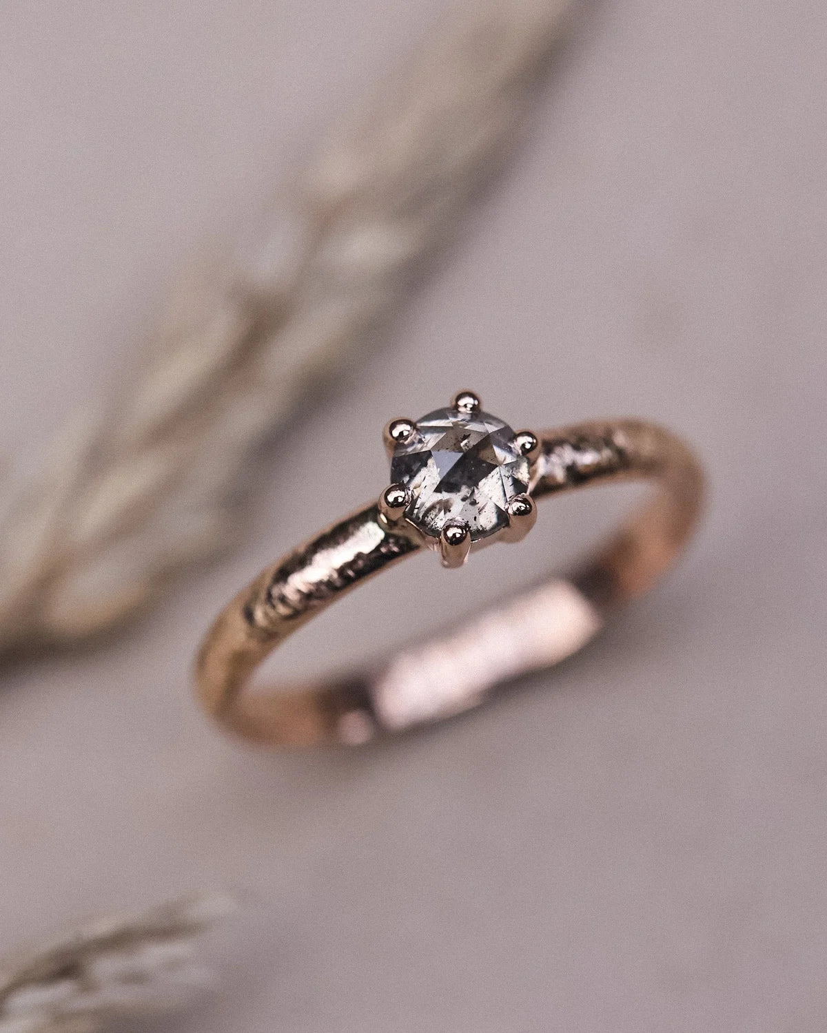 Editorial close-up of natural grey diamond horn texture ring