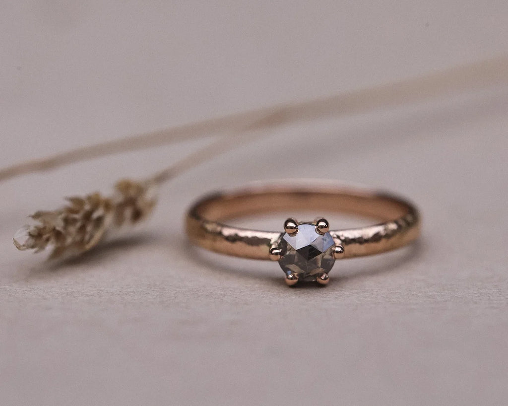 Front view of rose gold ring with grey rose-cut diamond and textured band